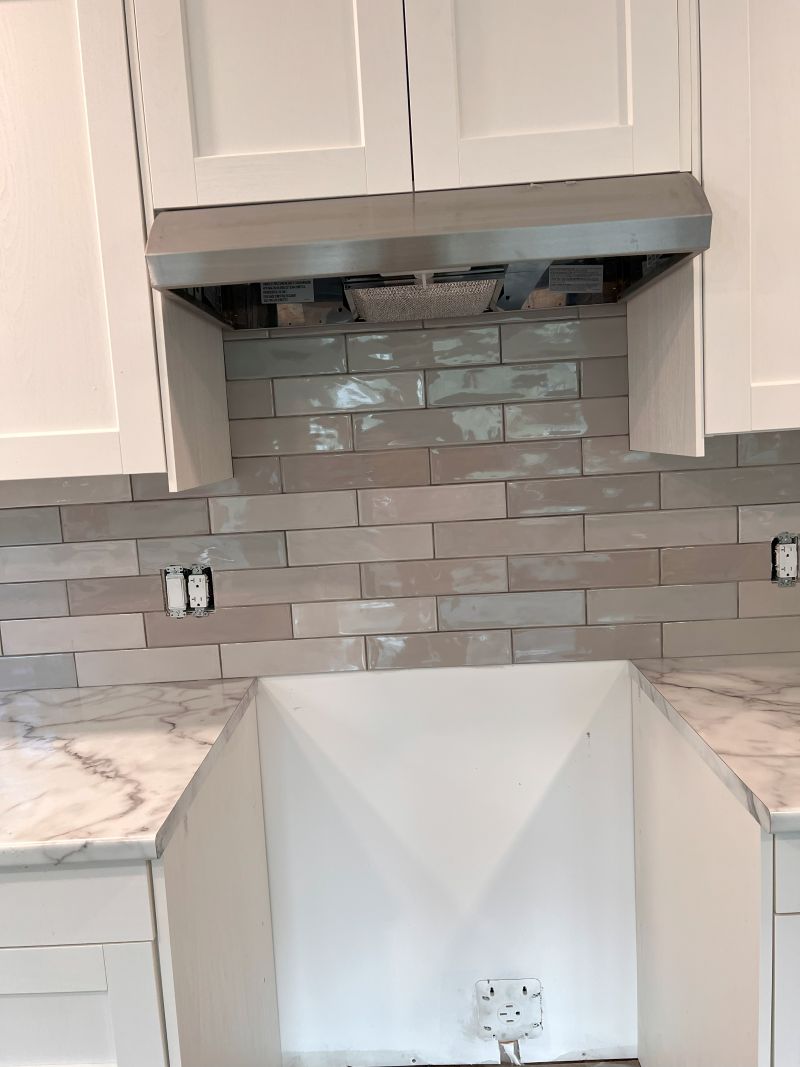 Finished tile backsplash and marble counter by Trevor Moon